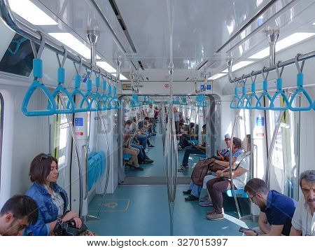 Istanbul, Turkey - June 24, 2019: Passengers And Blue Handholds In Marmaray Commuter Rail. Marmaray 