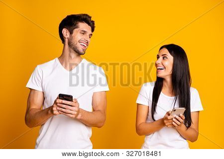 Photo Of Two People Holding Telephones Checking Feednews Laughing About Good Joke Wear Casual Clothe