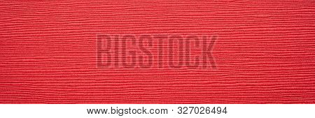 Japanese red linen washi paper with an embossed linear groove texture, panoramic banner