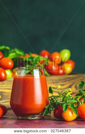 Glass Of Fresh Delicious Jummy Red Tomato Juice And Fresh Tomatoes In Wooden Box. Dark Background. C
