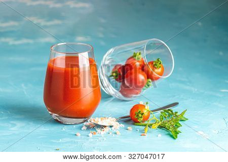 Glasses Of Fresh Delicious Jummy Red Tomato Juice And Fresh Raw Tomatoes With Pink Salt In Spoon On