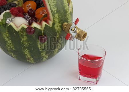 Fruit Basket And Juice Drain Tap. The Basket Is Made Of Watermelon And Filled With Different Fruits