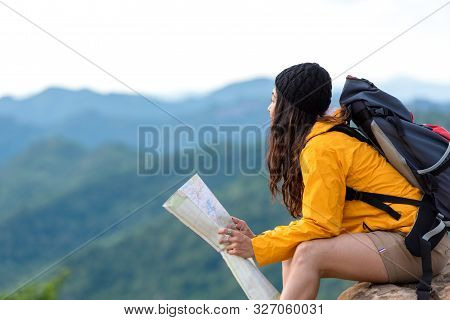 Asian Women Hiker Or Traveler With Backpack Adventure Holding Map To Find Directions And Sitting Rel