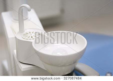 White Washbasin In Dentist Clinic. Stomatological Equipment.