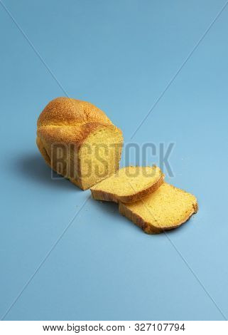 Tasty Cornbread, Freshly Baked, With Two Slices On Blue Background. Home-baked Bread With Golden Cor