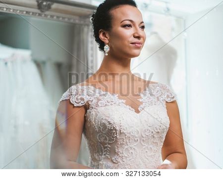 Beautifu bride choosing wedding dress in a wedding salon