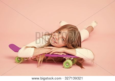 Spreading Happy Vibrations With The Penny Board. Small Girl Skater Relaxing At Penny Board Deck On P