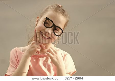Perfect Props For Partying. Happy Little Child Looking Through Glasses Props. Funny Small Girl Weari