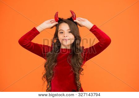 Fancy Imp. Little Girl Red Horns Celebrate Halloween. Carnival Concept. Small Child With Imp Style A