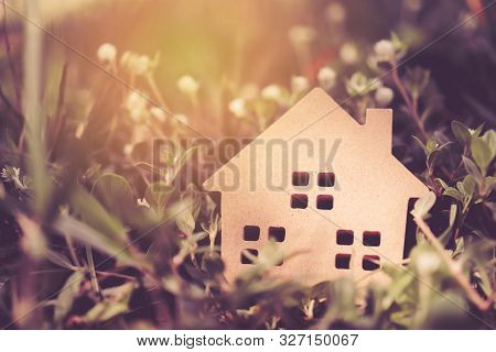 Closed Up Tiny Home Model On Floor Or Wood Board With Grass Background. Deam Life Have Own House Pro