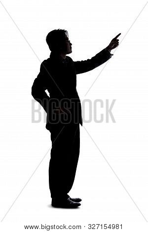 Full Body Silhouette Of A Businessman Isolated On A White Background. He Is Pointing At Copy Or Text