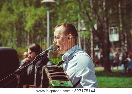 Russia, Siberia, Novokuznetsk - May 9, 2019: Musicians Sing Songs On The Street On Victory Day