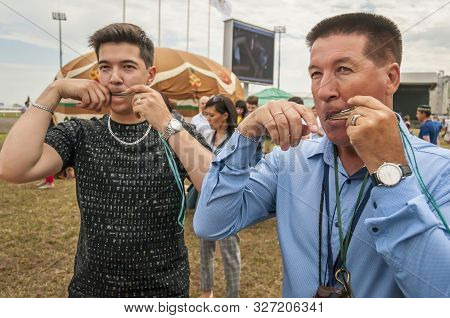 Ufa, Russia. July 12, 2019. Bashkir Turk Person Playing An Ethnic Lamellophone Instrument Known As J