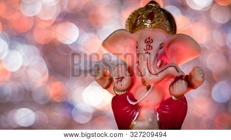 Ganesha Statue With Beutiful Lights In The Background For Ganpati Pooja Concept