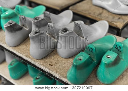 Plastic Lasts Used In The Manufacture Of Shoes. Row Of Plastic Shoe Lasts Used To Manufacture Modern