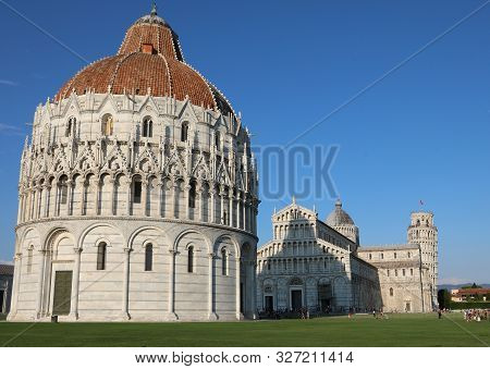 Pisa, Pi, Italy - August 21, 2019:  Big Baptistery On The Miracles Square Called Campo Dei Miracoli 