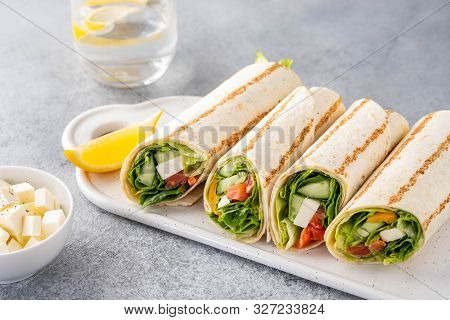 Wrap Sandwich, Roll With Fish Salmon, Vegetables And Cheese. Grey Background. Close Up.