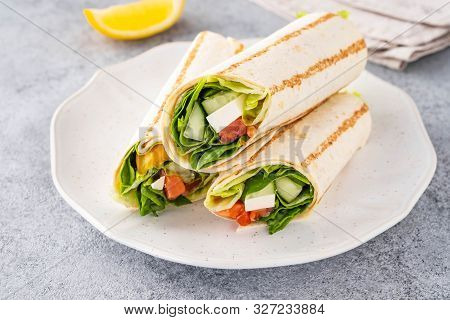 Wrap Sandwich, Roll With Fish Salmon, Vegetables And Cheese. Grey Background. Close Up.