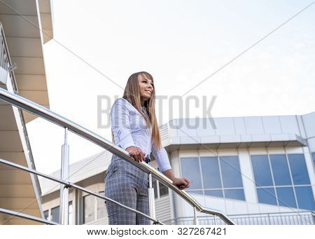 Business Woman Concept. Outdoor Portrait Of A Confident Smiling Business Woman Standing Near The Bui