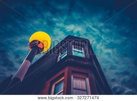 A Belisha Beacon Outside A Flat At Night In A Residential Area Of A British City