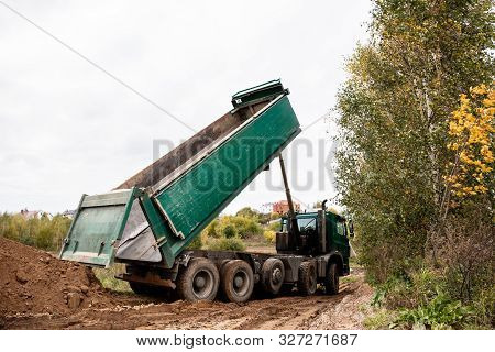 A Large 70-ton Dump Truck Brought Sand To A New Construction Site To Add Land