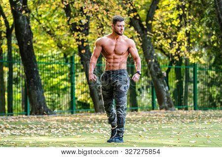 Handsome Muscular Shirtless Hunk Man Outdoor In Outdoor Setting. Showing Healthy Body. Halfnaked Spo