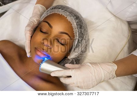 Ultrasound Chromotherapy. Hardware Cosmetology. Beautician Carries Out Procedure For Face Skin Rejuv