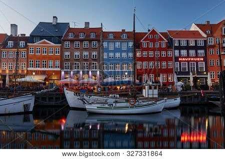 Colourful Facades And Restaurants On Nyhavn Embankment And Old Ships Along The Nyhavn Canal In Copen