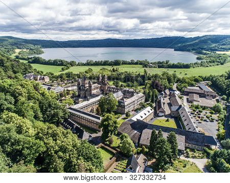 Aerial View On Laacher See Behind The Famous Abbey Maria Laach In Rhineland-palatinate, Germany