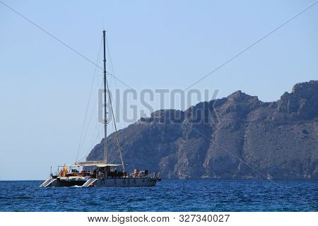 Mazarron, Murcia- October 2, 2019: Tourist Catamaran Full Of Tourists Furrowing The Coast In A Sunny