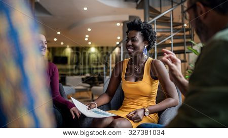 Beautiful North African Woman Smiling, Sitting In Candid South African Diverse Business Meeting