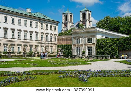 Salzburg, Austria - May 26, 2019: Visitors Enjoy The Gardens Of The Mirabell Palace (schloss Mirabel