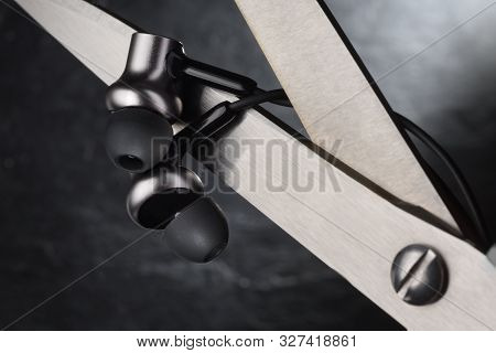 Scissors Cutting Wire On Earbuds. True Wireless Stereo Tws Earphones Concept