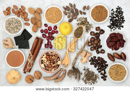 Herbal medicine and a variety of health foods for a healthy heart and cardiovascular system on marble background. Flat lay.