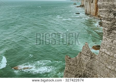 West Coast Of France. Étretat. Great View From A Great Height. The Sea Beats Against Rocks And Stone