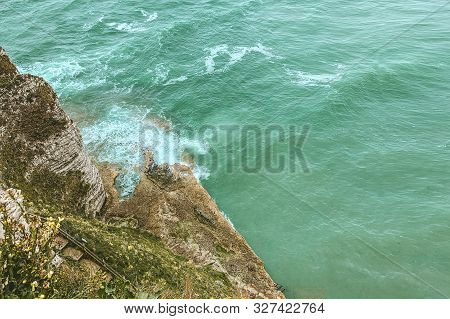 West Coast Of France. Étretat. Great View From A Great Height. The Sea Beats Against Rocks And Stone