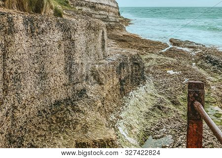 West Coast Of France. Étretat. Great View From A Great Height. The Sea Beats Against Rocks And Stone