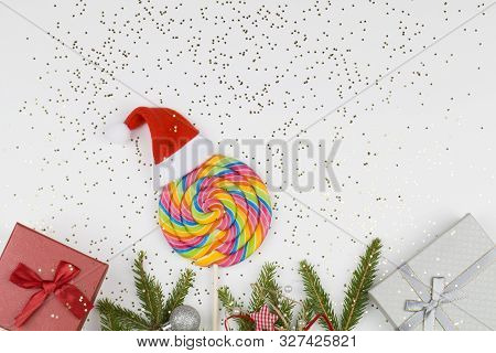 Christmas Gift, Colorful Lollipop And Fir Tree Branches On White Background With Small Stars. Holida