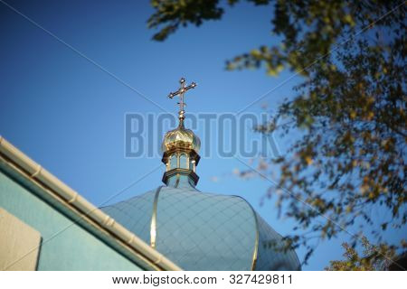 Dome Of The Orthodox Church And A Golden Cross Against A Blue Clear Sky