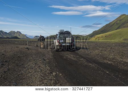 Iceland, Fjallabak Nature Reserve, August 1, 2019: Hiker And Off Road Car At Laugavegur Trail And F2