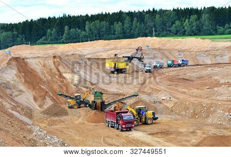 Wheel Front-end Loader Loads Sand Into A Dump Truck. Heavy Machinery In The Mining Quarry, Excavator