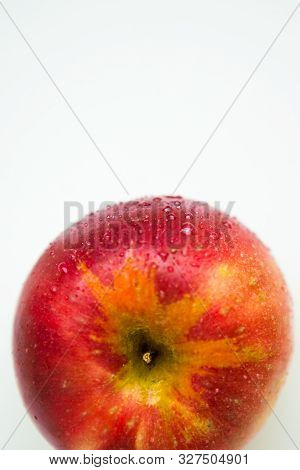 One Red Apple With The Water Drops On The White Background