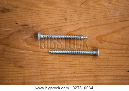 Metalware (bolt, screw) on the wooden background