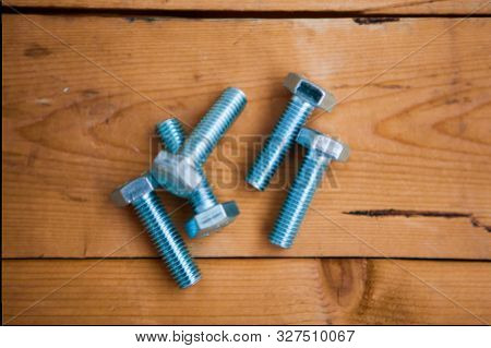Metalware (bolt, Screw) On The Wooden Background
