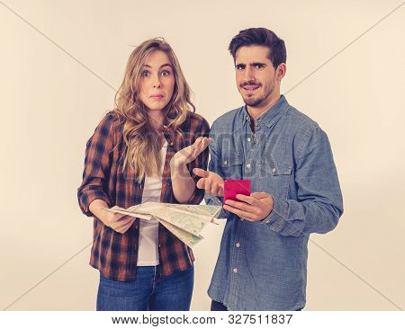 Young Couple Searching For Directions Using A Map And Gps On Mobile Phone.