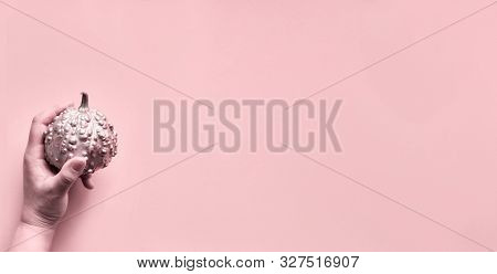 Halloween Panoramic Image Toned In Pink With Hand Holding Decorative Pumpkin Painted Metallic Pink C