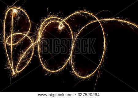 Fiery Word Boo From Bengal Lights At Night. Inscription Sparklers Boo On Dark Background. Happy Hall