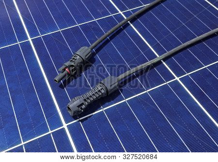 Solar Pv Connectors Male And Female Laid On Solar Panel Surface