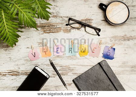 Viernes Sign And A Cup Coffe On A Desk (friday)