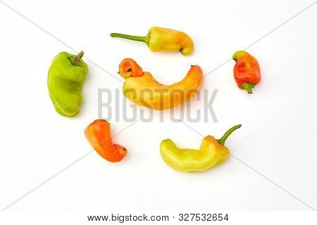 Trendy Ugly Organic Fruits And Vegetables. Peppers On White Background. Misshapen Produce, Deformed 